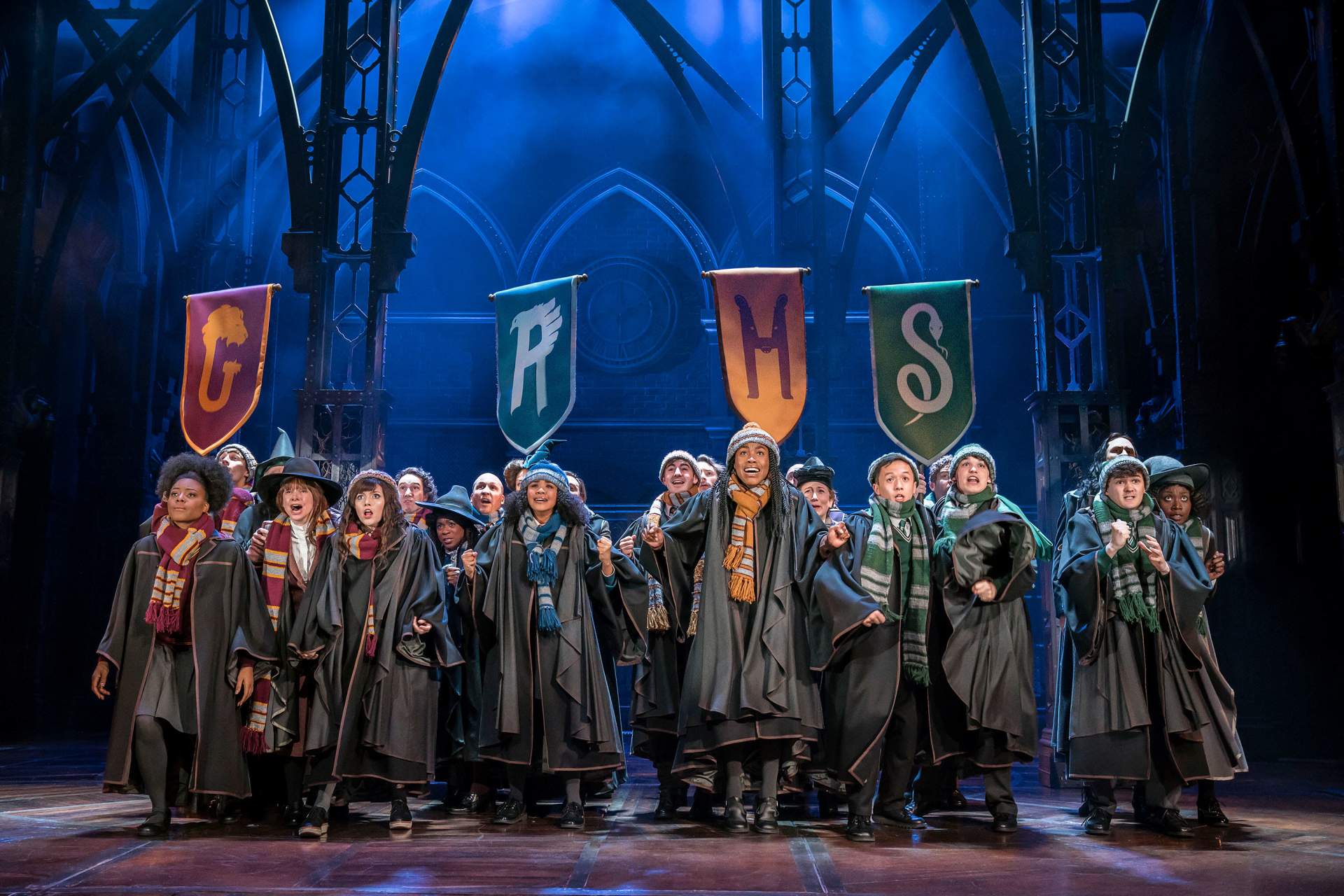 harry potter play on stage group of children dressed up 