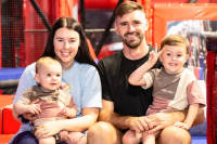 family smiling at ninja warrior