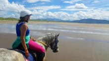 Woman horse riding on beach at Dingle Horse Riding