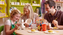 Family painting pottery at Corris Craft Centre in Machynlleth