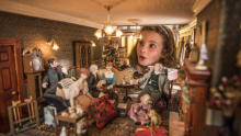 Girl looking into doll house at Thirlestane Castle in Lauder