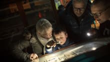 Family exploring bones and fossils at Sedgwick Museum of Earth Sciences in Cambridge