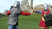Kids fighting as knights at Corfe Castle in Wareham