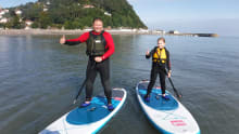 Dad and daughter paddle boating at Channel Adventure in Minehead