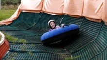 Girl snow tubing at Midlothian Snowsports Centre in Edinburgh