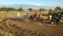 Racers speed on dirt track at Rally Karting in Huntingdon