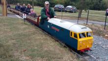People on mini train at Barnards Miniature Railway in West Horndon