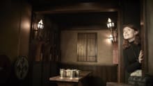 A little girl peering around the corner of an escape room at Escape Hunt