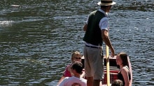 People in boat on river at Cambridge Punt Company