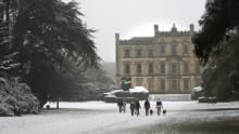 People walking through snow at Elvaston Castle 