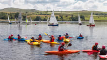 People kayaking at Hollingworth Lake Activity Centre in Littleborough