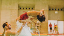 Boy flipping in swimming pool at London Aquatics Centre in London