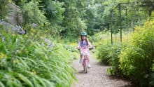 Girl on bicycle at Moss Bank Park in Bolton