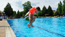 Boy jumping in pool at Guildford Lido