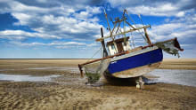 Boat left standing at Meols Beach in Wirral