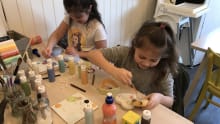 Two young kids enjoy painting pottery at Canny Crafty in Gosforth 