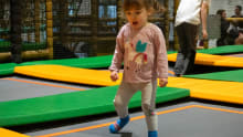 A little girl bouncing on a trampoline at Carerton Soft Play and Trampoline Park