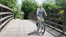 Two girls cycling at River Lee Country park