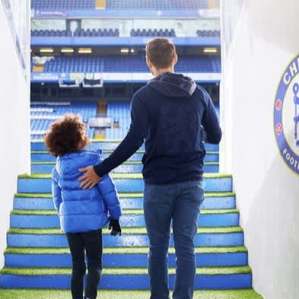 Parent and child walking down the players’ tunnel at Stamford Bridge on the Chelsea FC Stadium Tour