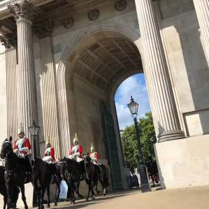 Close-up view of the changing of the Guard on horseback passing through Wellington Arch in London