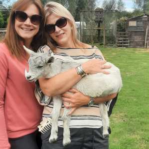 Small family group meeting farm animals during a private tour