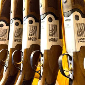Participant aiming a laser shotgun at flying clay targets