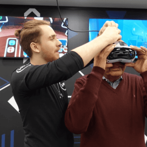 Two people wearing VR headsets playing together