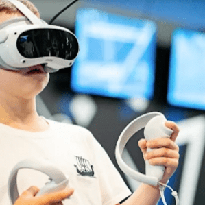 Staff member helping visitor with VR headset adjustment
