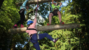 Kids climb swinging log ladder at Live For Today Adventures Ripley