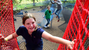 Girl on rope bridge at Treetop Nets in Windermere