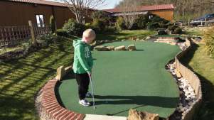 Boy playing golf at Crazy Golf @ York Golf Range