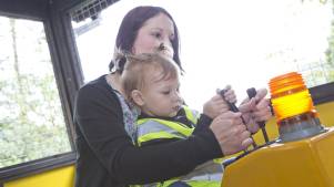 Mum and baby on tractor at Gulliver's Kingdom in Matlock Bath