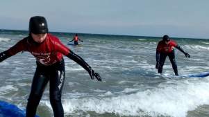 Kids surfing at New Wave Surf School in Lossiemouth