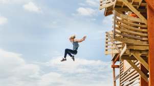 Girl jumping off platform at Hangloose Adventures in Bodelva