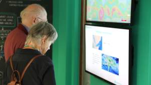 Couple reading display at ShelterBox Visitor Centre in Truro