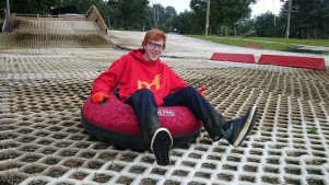 Boy tubing on ski slope at Gloucester Ski and Snowboard Centre