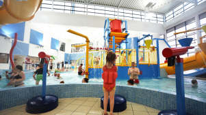 Families swimming at Huddersfield Leisure Centre Splash Park