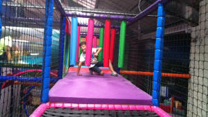 Boy on soft play frame at Rock Over Climbing in Manchester