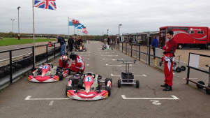 Riders by go karts at Ellough Park Raceway in Beccles