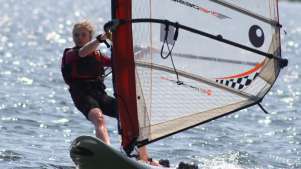 Girl wind surfing at Hollingworth Lake Activity Centre in Littleborough