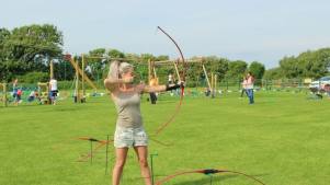Woman doing archery at Warren Farm Holiday Centre in Burnham on Sea