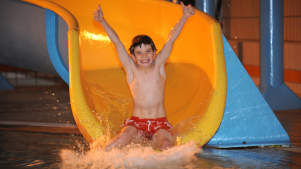 Boy on water slide at King Alfred Leisure Centre in Hove