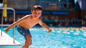 Boy jumps into swimming pool at Swan Pool and Leisure Centre in Buckingham