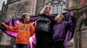 Guide and kids outside castle at Mercat Tours in Edinburgh