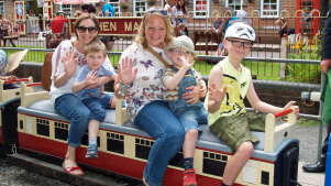 Family on miniature train at Mizens Railway in Woking