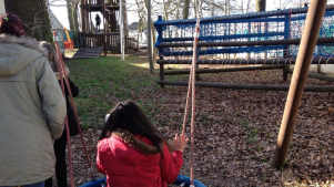 Girl on swing at Goldhill Adventure Playground in Leicester