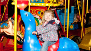Girl on carousel at The Ice Factor Kinlochleven