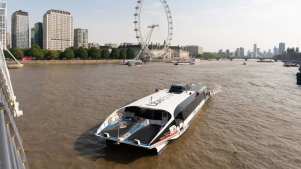uber boat on the Thames with london eye in the background