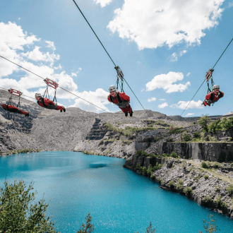 Three people riding the worlds fastest zip line at zip world quarry