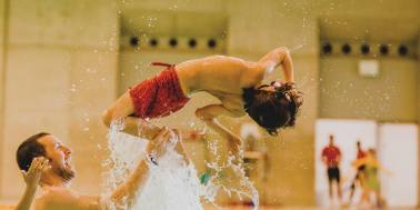 Boy flipping in swimming pool at London Aquatics Centre in London